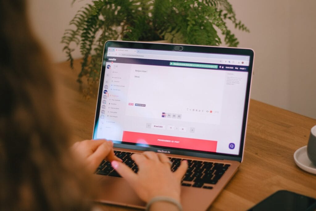 SoftExpert: 9 Vagas Remotas Abertas Person using a laptop in a work environment.