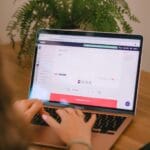 SoftExpert: 9 Vagas Remotas Abertas Person using a laptop in a work environment.