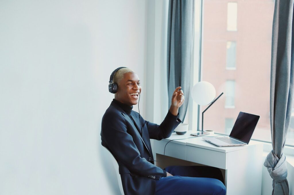 Customer Success Home Office man in black long sleeve shirt sitting on blue chair